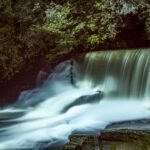 Upper Aberdulais Falls with late afternoon sun bouncing off the water
